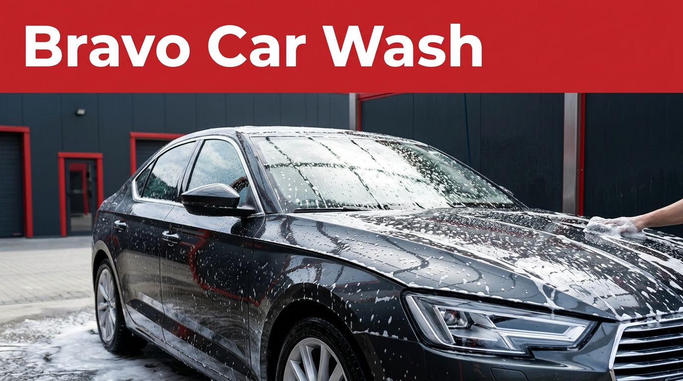 A glossy dark sedan covered in thick white foam inside a modern car wash bay.