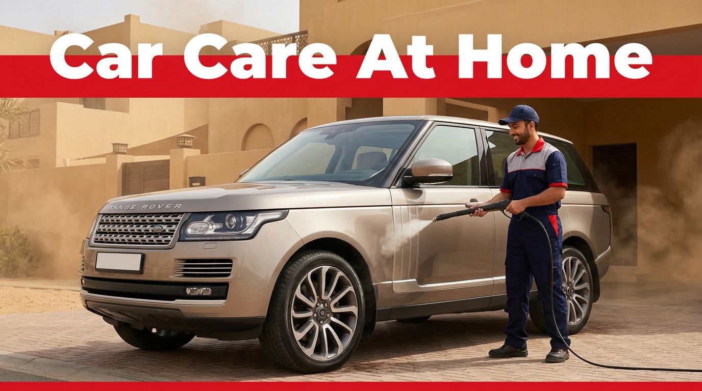 A technician washing a luxury SUV in a sunny Dubai driveway.