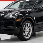 A clean SUV sits in a bright detailing bay with car-care tools nearby.