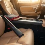 A clean car interior with a vacuum nozzle, leather seats, and a red Fresh Cabin banner.